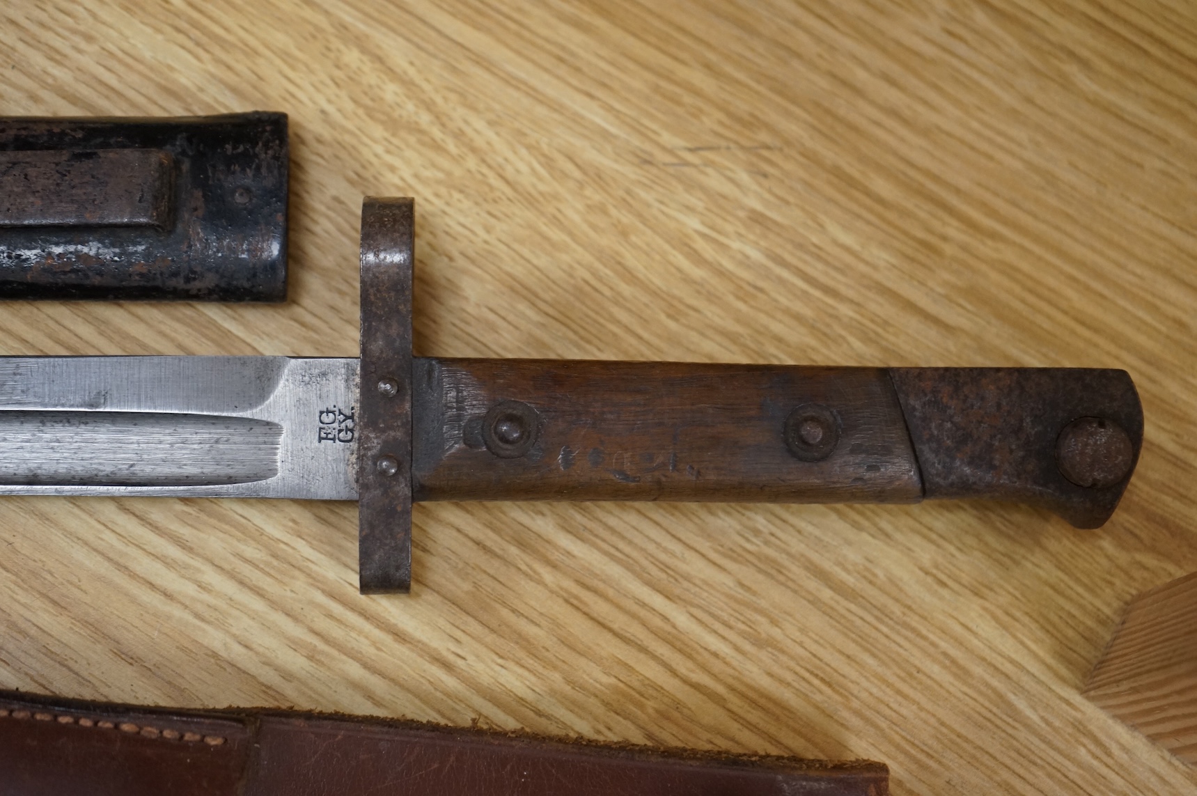 A 1907 bayonet by Wilkinson in its steel mounted leather scabbard, another similar with leather frog, two small British bayonets, a Continental bayonet, and two assorted hunting knives (7)